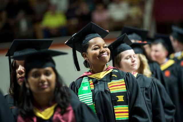 Candidates receiving master's and doctoral degrees process in the Graduate Commencement ceremony in Cassell Coliseum.