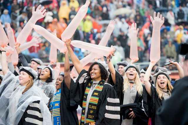 Graduates in the veterinary school continue the waving glove tradition.