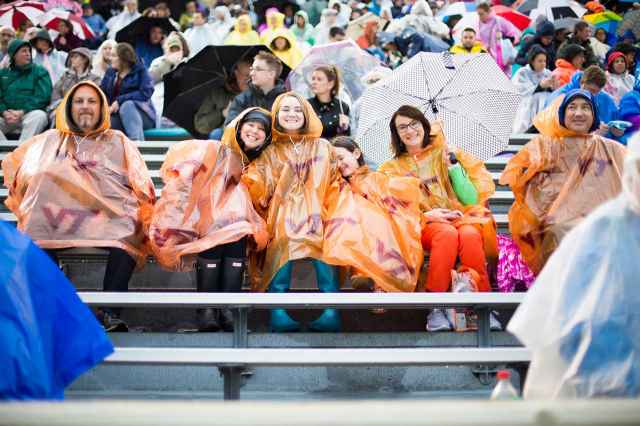 Families donned ponchos and other rain gear to stay dry during Friday's ceremony.