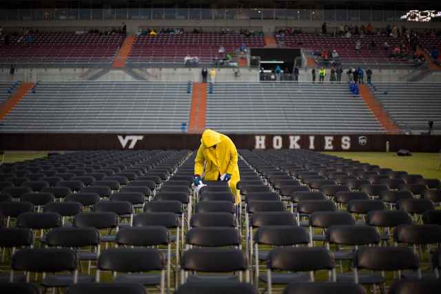 Facilities crews worked the early hours before Friday's ceremony to keep the seats dry.