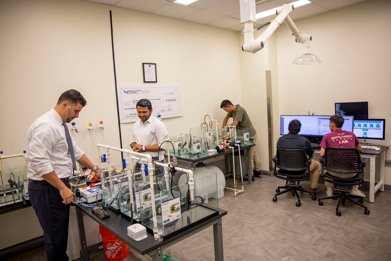 faculty and students working in a lab 
