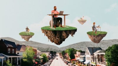 A photo illustration of remote workers sitting at desks that are floating above a small town streetscape on bits of earth (grass, roots, dirt, all mid-air). 