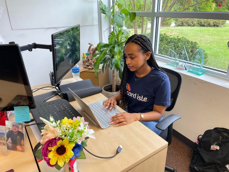 Federal work-study student MIeraf Teshome does work on a laptop for her employer, Card Isle.