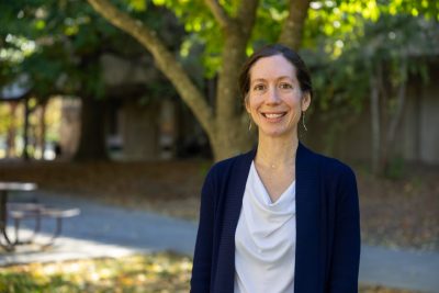 woman in white blouse with a blue sweater