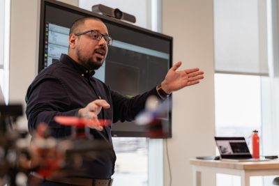 Omar Hashash gesturing as he discusses his resaerch.