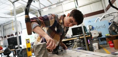 Isaac Rogers works with a 3D-printed piece in the Design, Research and Education for Additive Manufacturing Systems (DREAMS) Lab at Virginia Tech. Photo by Alex Parrish for Virginia Tech.