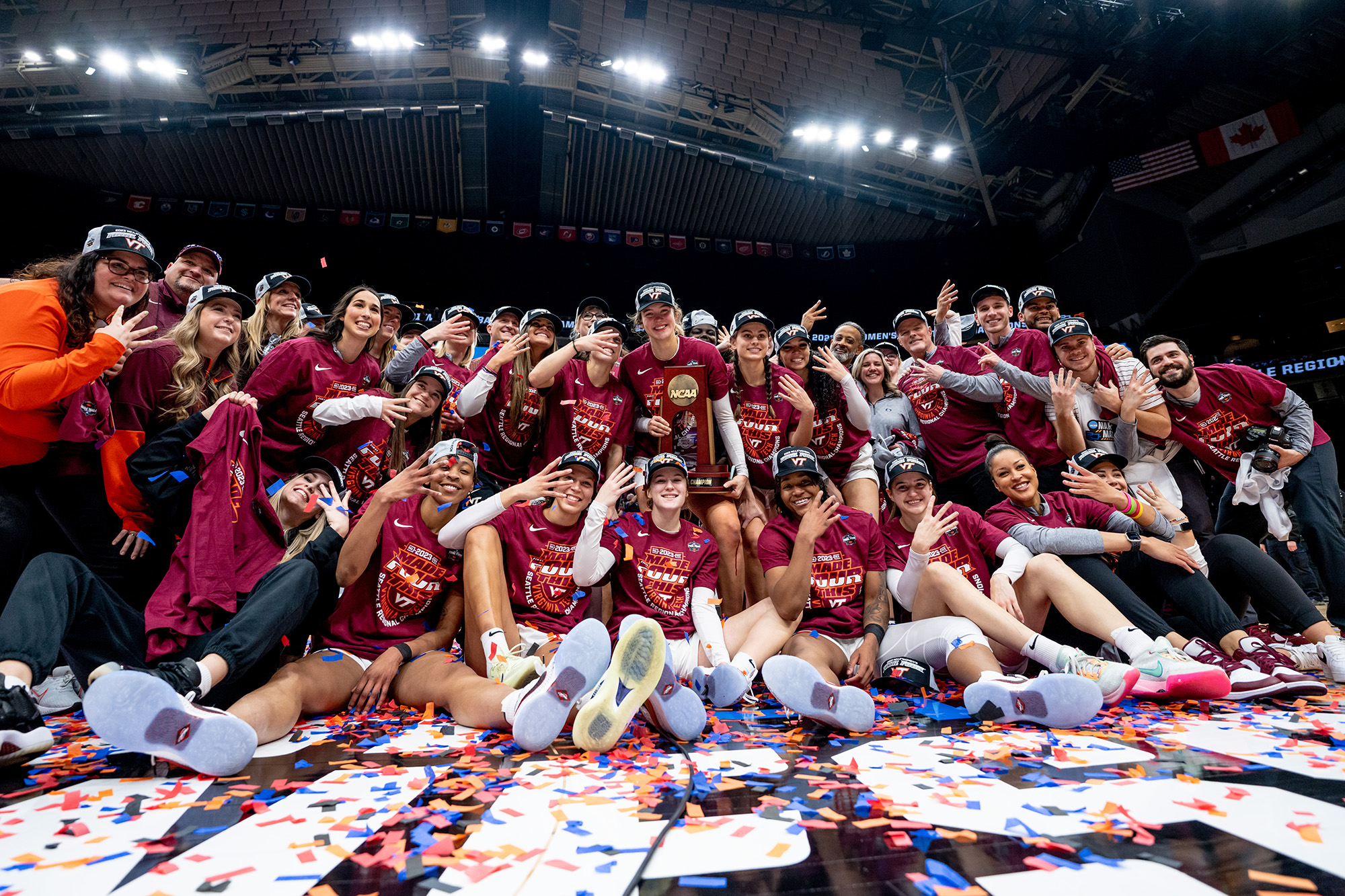 The Virginia Tech women's basketball team pose with the regional trophy on Monday