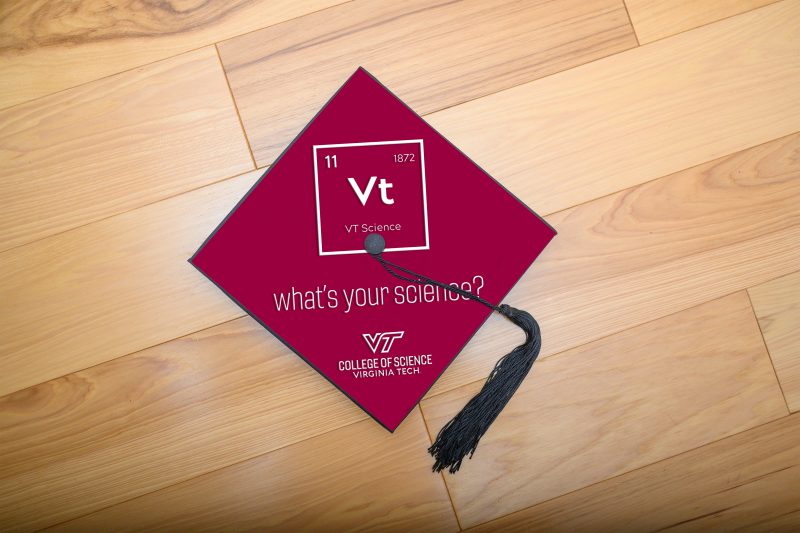 graduation cap on wood floor with "What's your science?" mortar board