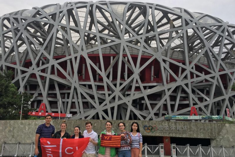 Virginia Tech students stand in front of the Olympic Stadium in Beijing, China
